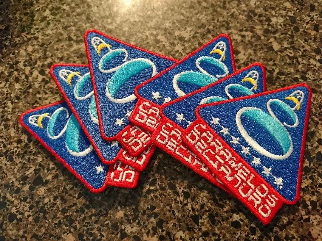 A collection of blue and red rectangular embroidered badges